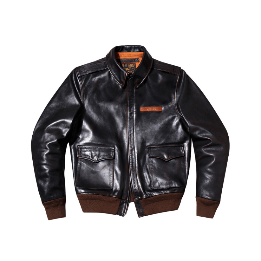 A black leather aviator jacket with brown ribbed trim at the hem, cuffs, and collar, featuring a zippered front, two flap chest pockets, and a small brown leather brand patch on the left chest.