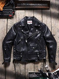 Black leather jacket on a wooden surface with a typewriter and motivational quote in the background.